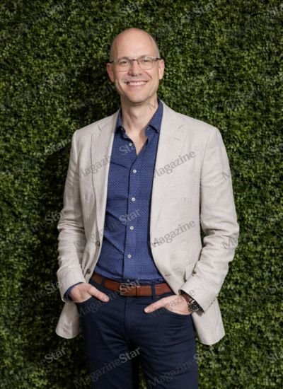 Neil Bicknell smiling in a beige blazer, Joanna Scanlan’s husband