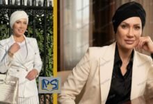 Portrait of Emily Abraham wearing a beige blazer and black headscarf