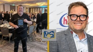 Gary Carr holding British Parking Awards 2024 booklet alongside comedian Alan Carr at a formal event