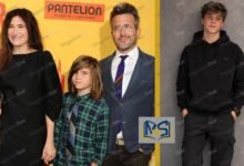 Kathryn Hahn and Ethan Sandler with their son Leonard Sandler at a red carpet movie premiere.