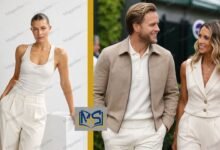 Amelia Tank posing in a white sleeveless outfit alongside husband Olly Murs at a public event, both wearing coordinated neutral-colored clothing.